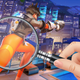 A cartoon hand holds a magnifying glass over Overwatch character Tracer's orange-leggings-covered backside.